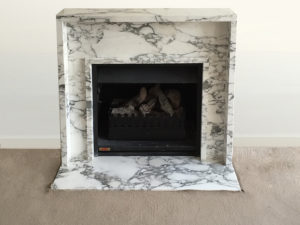 contemporary arabescato marble fireplace and a hearth